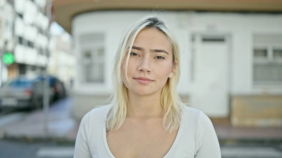 Confident young woman standing on the street